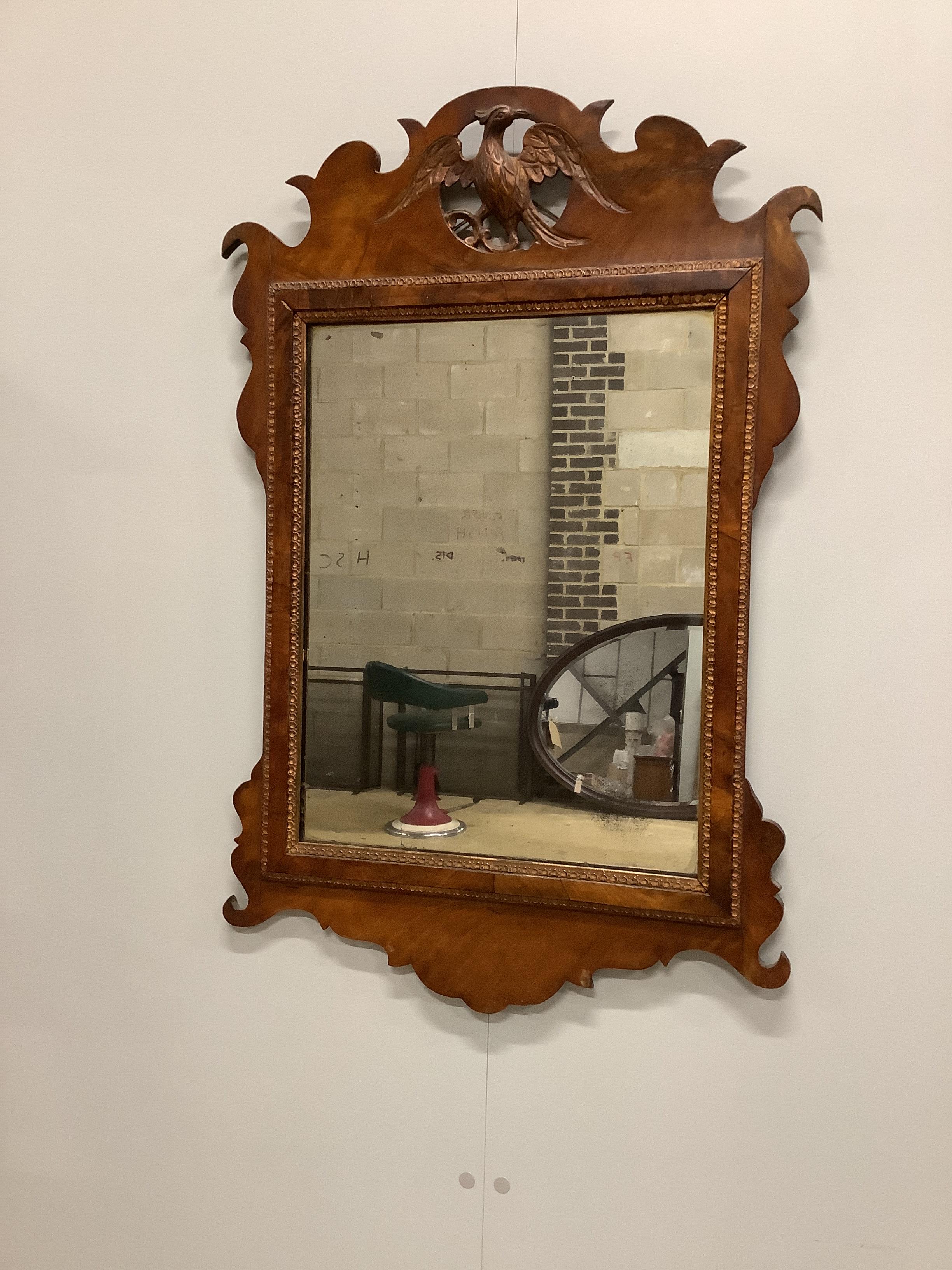 An 18th century style walnut fret cut wall mirror, width 55cm, height 83cm